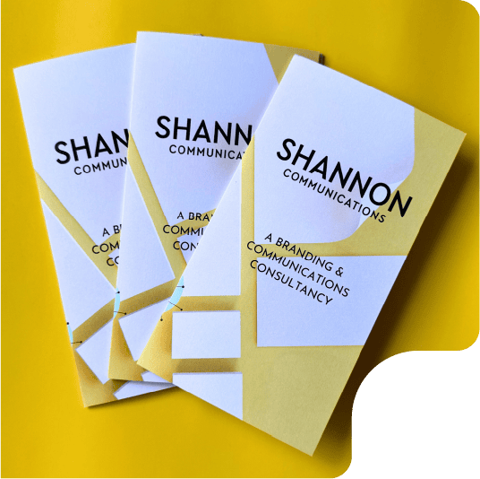 PLACEHOLDER-shannoncomms_1 Shannon Communications branding brochures on yellow surface