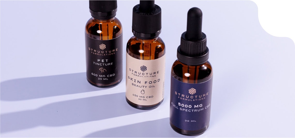 product-packaging Three CBD oil bottles from Structure Formulations