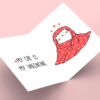 Valentine card: Cat wrapped in heart-patterned blanket.