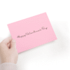 Pink Valentine's Day card, hand holding it.