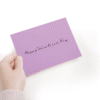 Hand holding pink Valentine's Day card