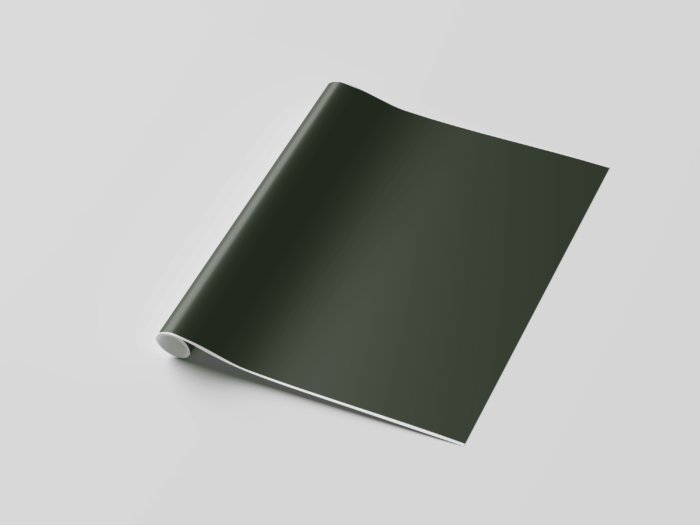 Rolled green wallpaper on white surface