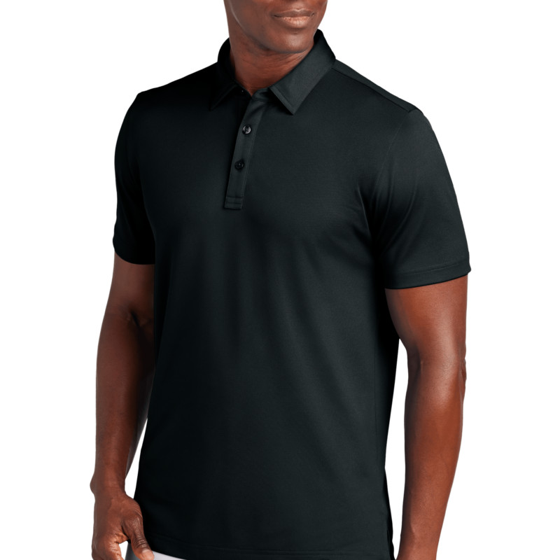 Man wearing black polo shirt and white pants.