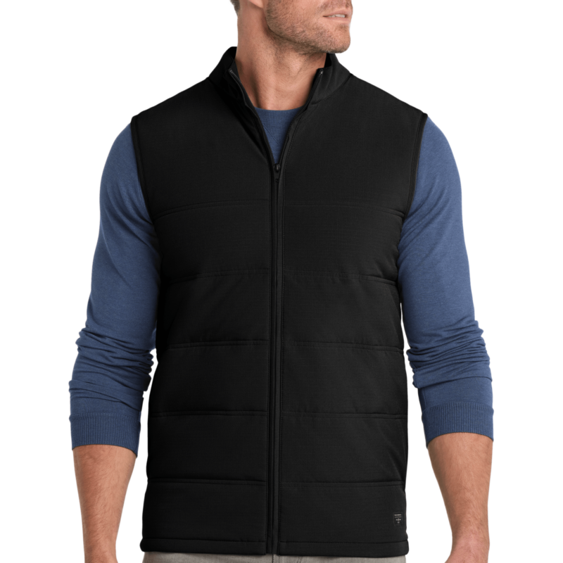 Man wearing black vest and blue shirt