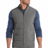 Man wearing gray quilted vest, blue sweater