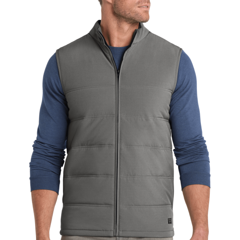 Man wearing gray quilted vest, blue sweater