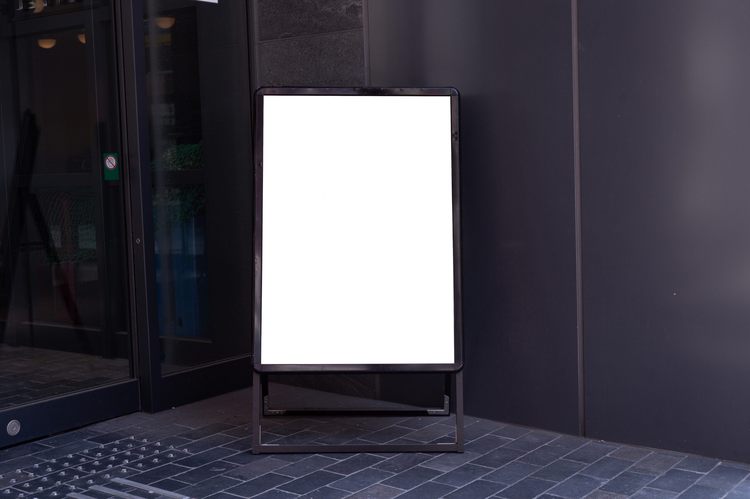 Blank vertical sandwich board outside building entrance