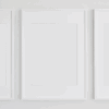 Three white frames on plain white wall.