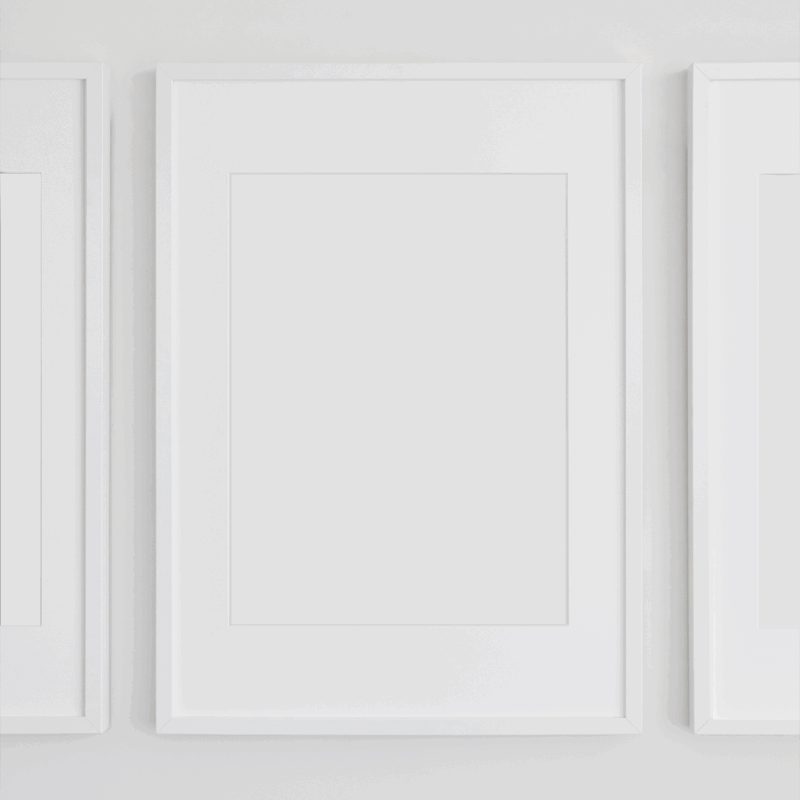 Three white frames on plain white wall.