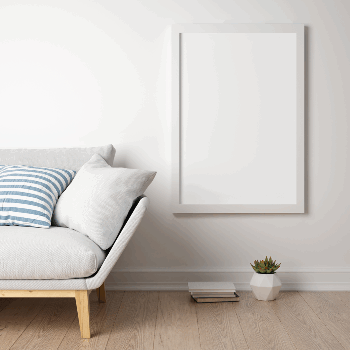 Minimalist living room with framed poster and succulents.