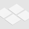 Four blank white square papers on gray background.