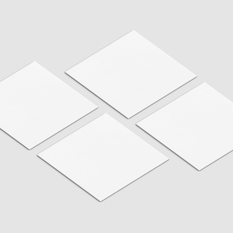 Four blank white square papers on gray background.