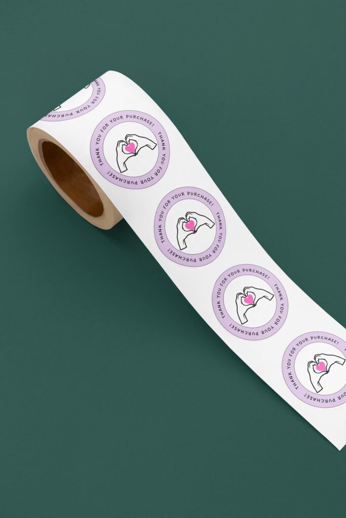 Roll of 'Thank You' stickers with heart design.