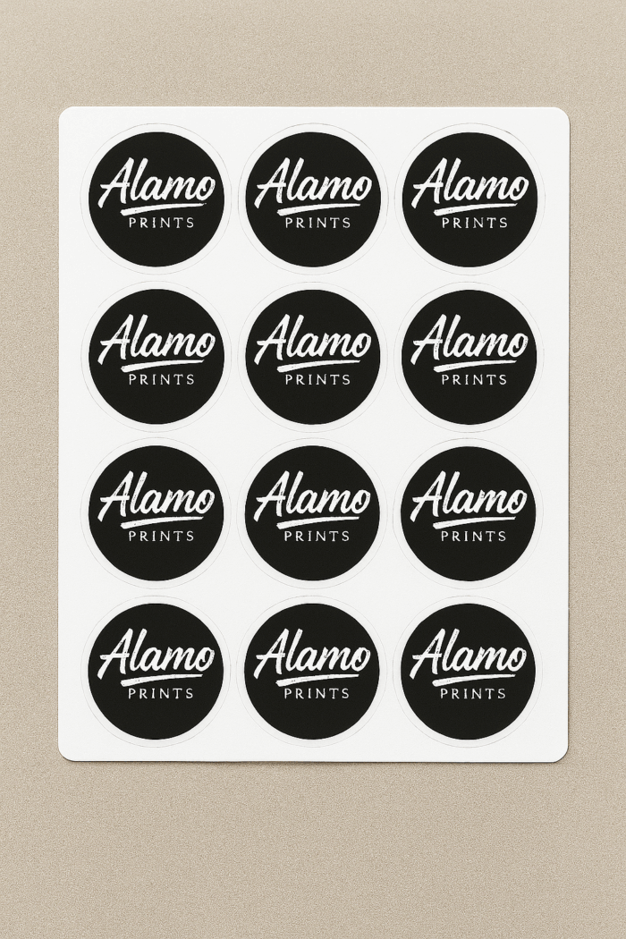 Sheet of Alamo Prints black round stickers.