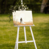 Wedding photo on easel, outdoor setting