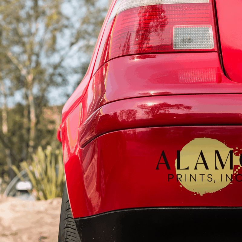Red car bumper with Alamo Prints, Inc. logo.