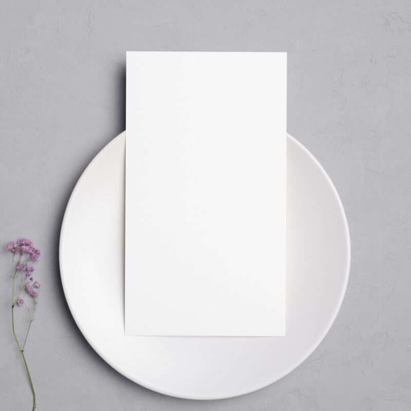 Blank card on plate with purple flowers