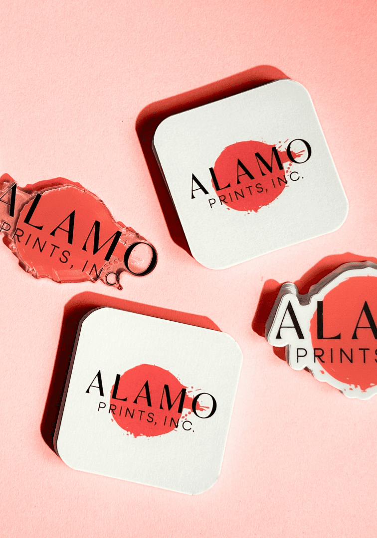 Alamo Prints Inc. logo on merchandise against pink background.