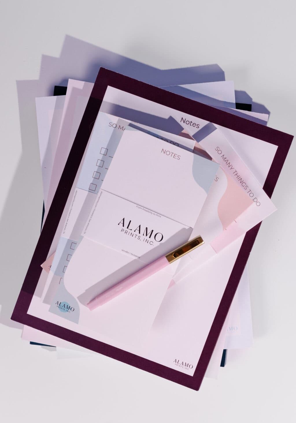 Stack of stationery with pink pen